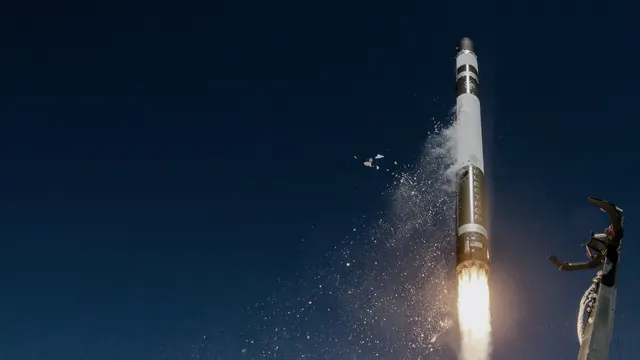 Rocket Lab Electron rocket lifting off into a dark sky